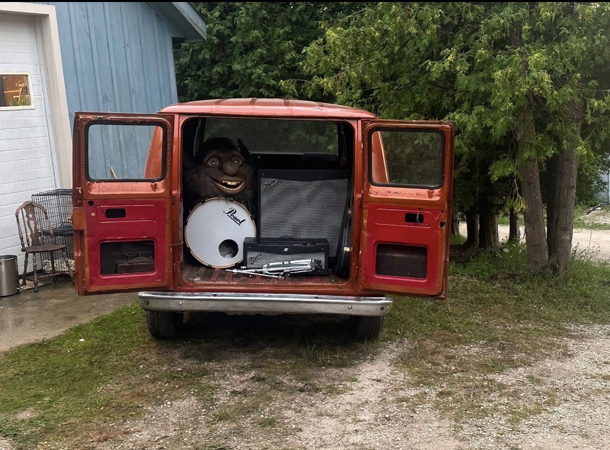 Billy da Kid's red touring van loaded with musical equipment