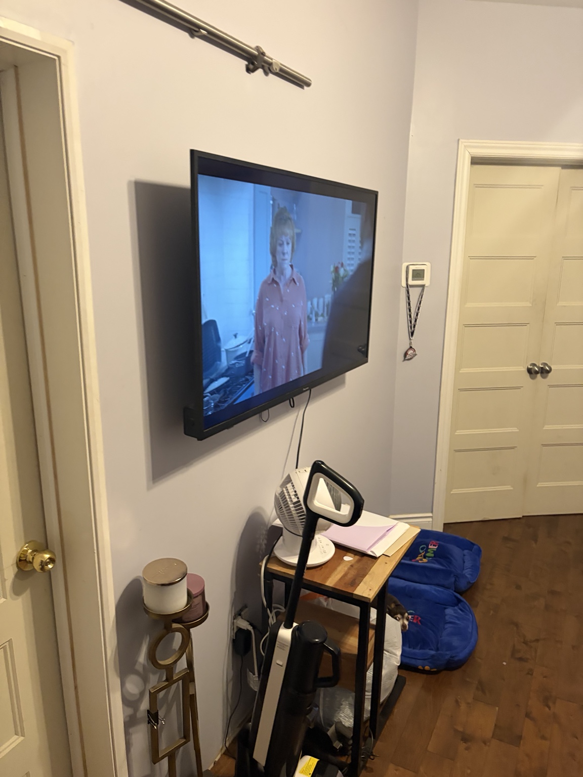 The wall-mounted television in Jonny Electric's living room